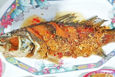 Deep fried sea bass topped with sweet sour and hot sauce